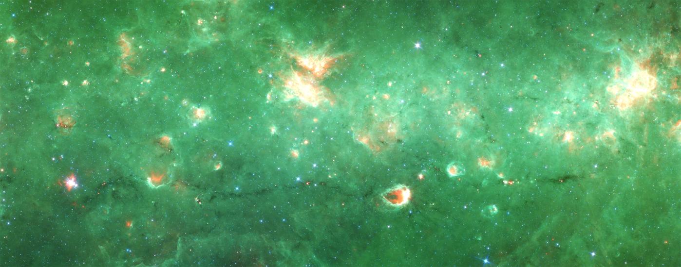 A partial view of a green-colored nebula inside the Milky Way with many orange-colored sections throughout.