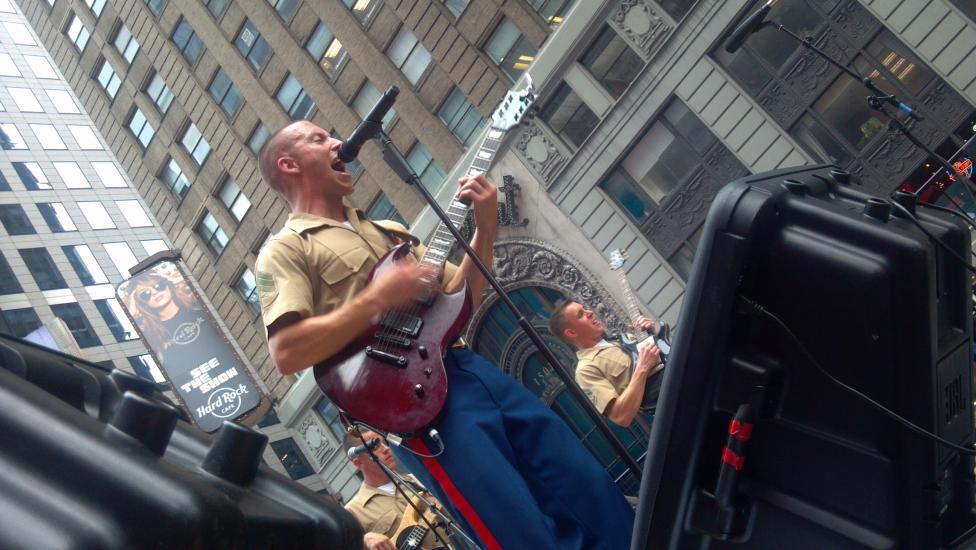 A group of Marine Corps musicians perform as part of a rock band.