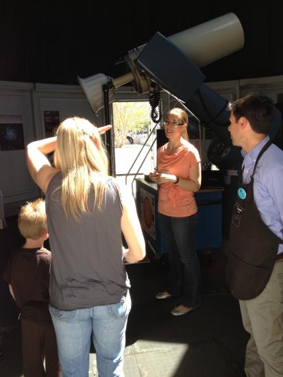 Museum visitors speak with a museum astronomy expert inside the Museum's observatory.