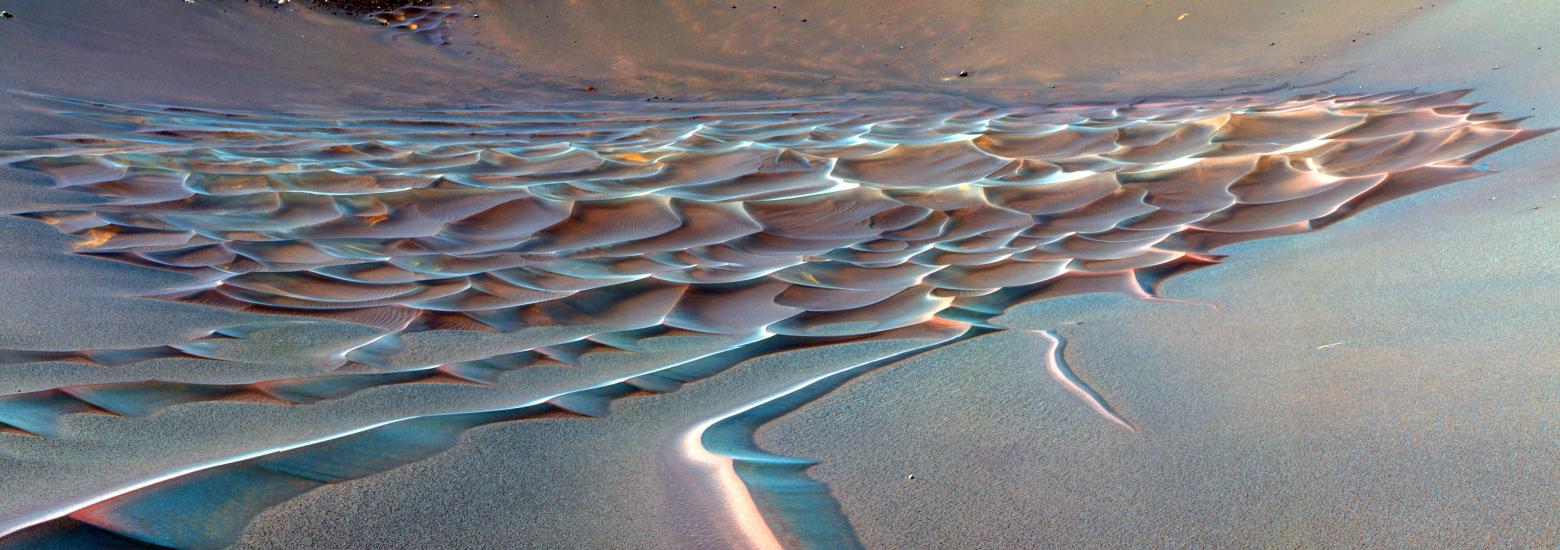 A area of rippling sand dune formations on Mars.