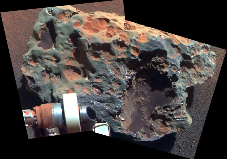 A large meteorite found and tested on Mars by Opportunity Rover, whose arm is visible in the view of the meteorite.