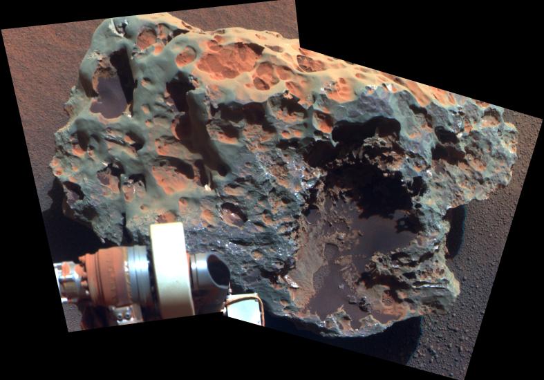 A large meteorite found and tested on Mars by Opportunity Rover, whose arm is visible in the view of the meteorite.