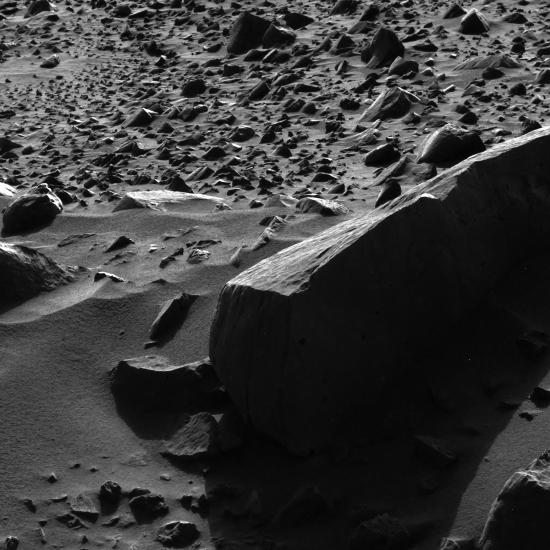 A rock on Mars with remarkably tall shadows.