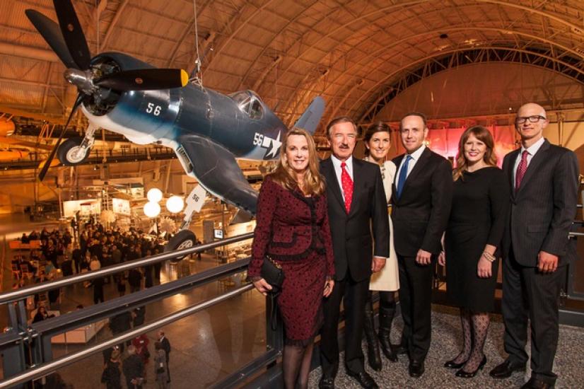 A group of family members, one of which is the namesake of the Steven F. Udvar-Hazy Center, stand together for a photo inside the museum's Udvar-Hazy Center.