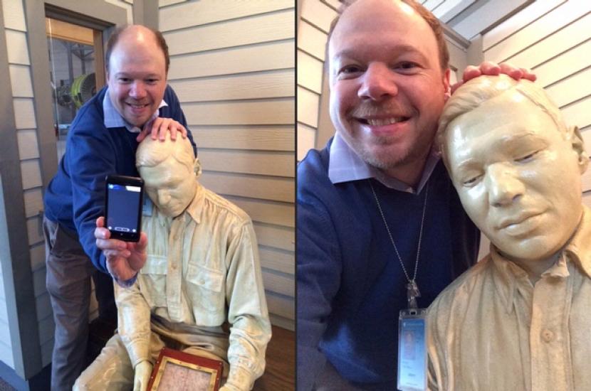 Tim Grove, Chief of Museum Learning at the Museum, takes a selfie with a plaster cast of himself in a museum exhibit.