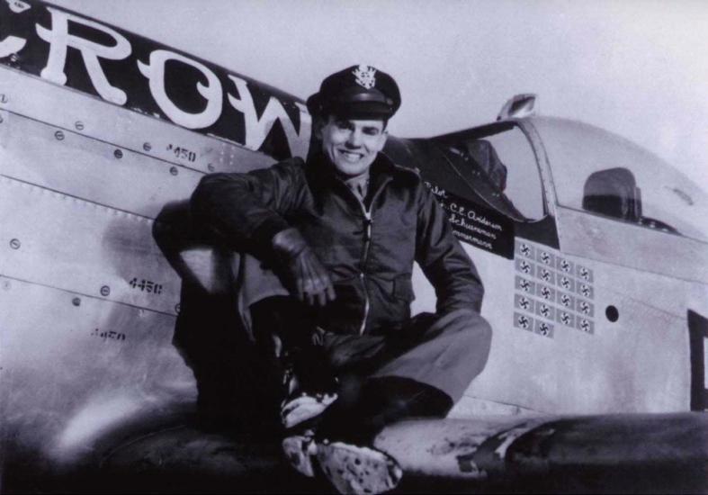 Col. Clarence E. "Bud" Anderson, USAF (Ret.), a white man, poses on the wing of an airplane.