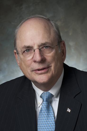 Norm Augustine, a white man, poses for a portrait.