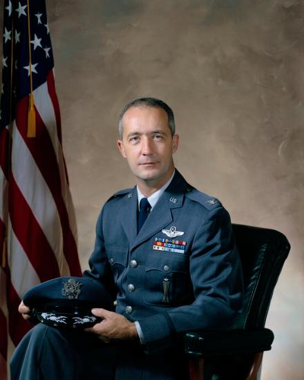 Gen. James A. McDivitt, a white male, sits for a professional portrait in his U.S. Air Force uniform.