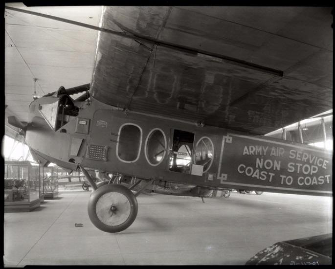 Side view of a monoplane with one engine on display in its prior home in the Smithsonian Castle.