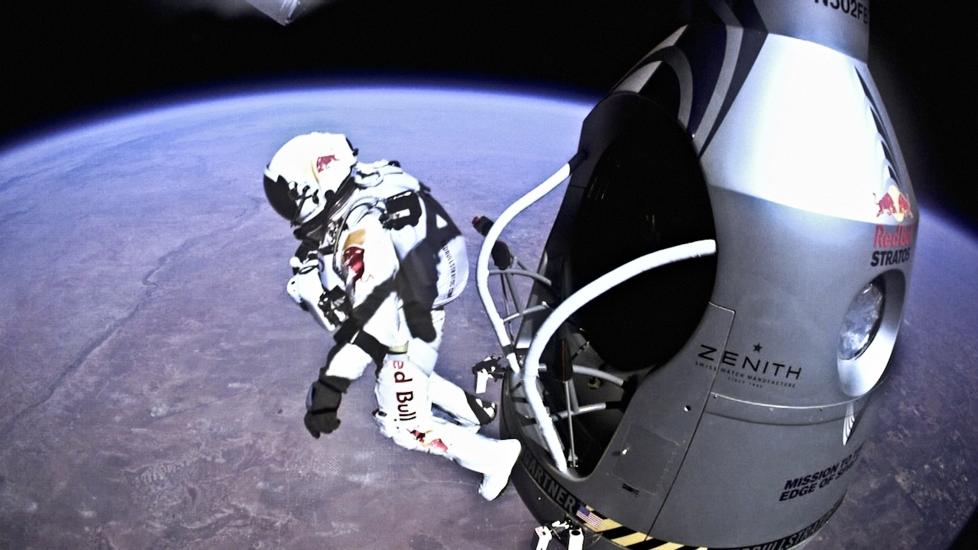 Felix Baumgartner, a pilot wearing a white high-altitude suit, jumps from near space as part of a flight test.