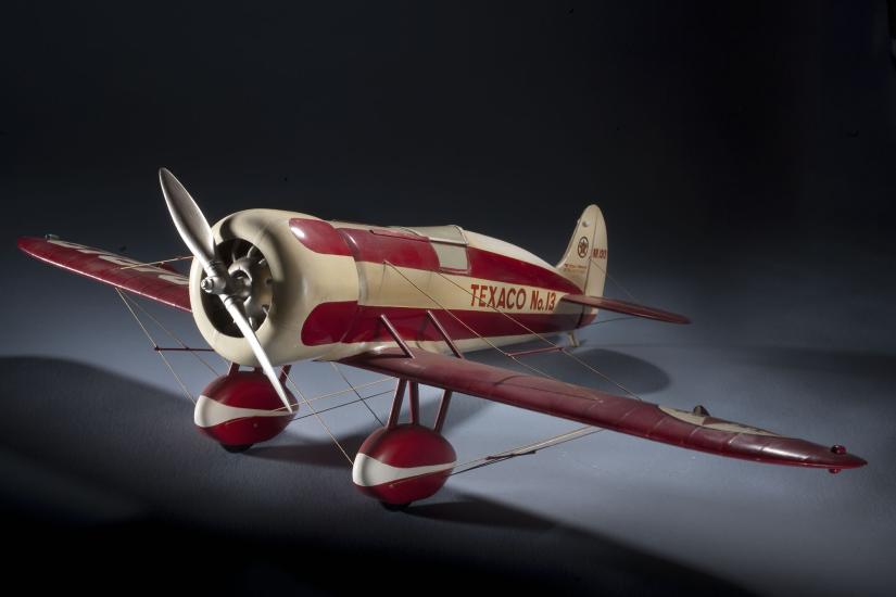 White and red monoplane model with one engine. "Texaco No. 12" is painted in red near the rear of the fuselage.