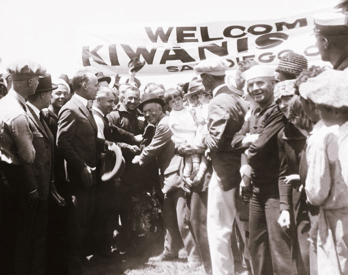 Pilots John Macready and Oakley Kelly, both male, receive a celebration after landing the T-2 plane.