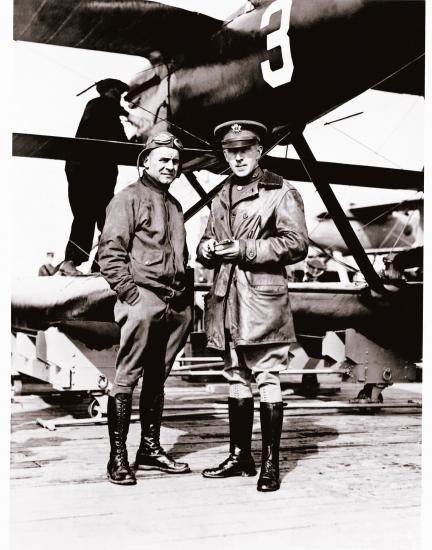 Jimmy Doolittle and Lt. Cyrus Bettis, both of whom are white male pilots, stand together under an aircraft.