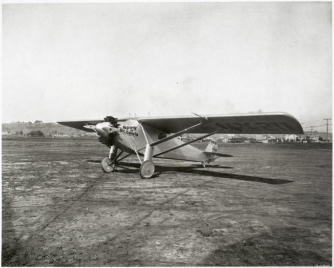 The Spirit of St. Louis, a monoplane with one engine, on flat land.