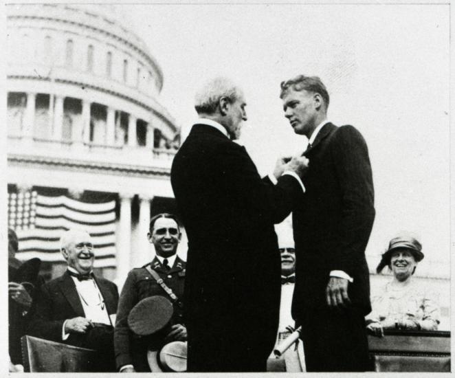 Charles Lindbergh receives a medal at a ceremony following his feat as the first to pilot alone during a nonstop transatlantic flight.