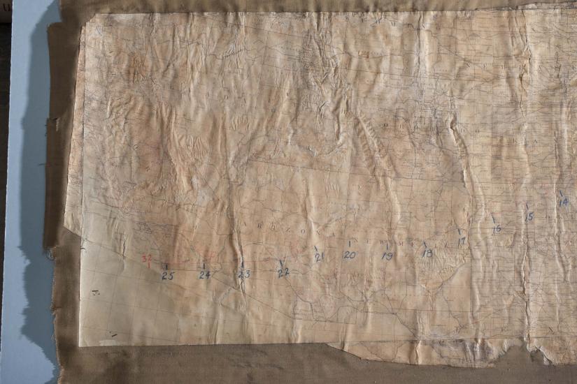 Close-up view of a faded map of United States with a focus on the western half of the country. The map was used to list stops on the first successful transcontinental flight.