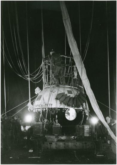 Close-up view of the large gondola of an air balloon with a light and dark colored base.