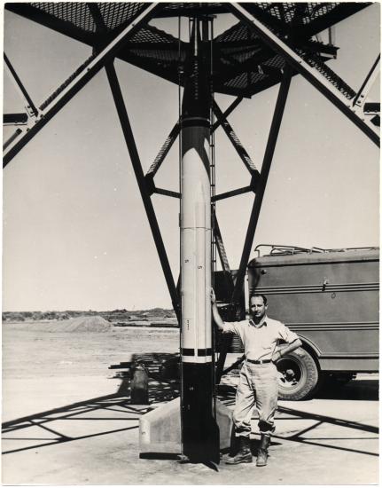 Frank Joseph Malina standing next to a rocket