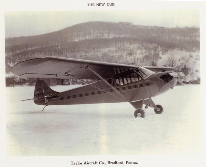 Side view of light-colored monoplane with one engine on ground.