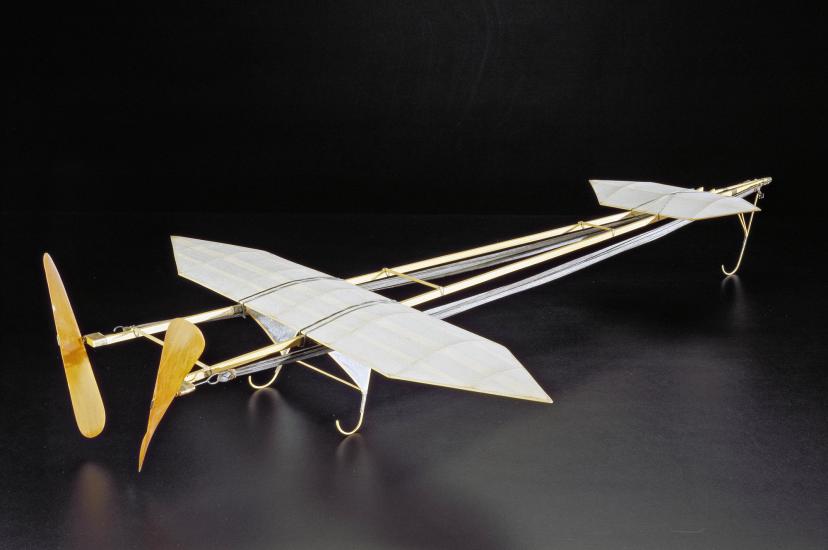 Gliding racing plane model with two separate sets of wings and rubber bands to power the plane.