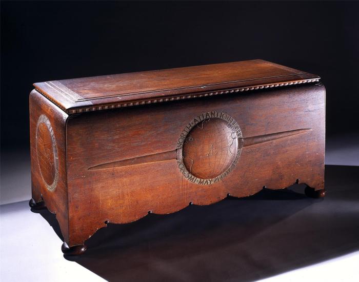 Wooden chest commissioned to hold the trophies, plaques, and memorabilia belonging to Amelia Earhart. The chest features motifs highlighting three of Earhart's milestone flights.