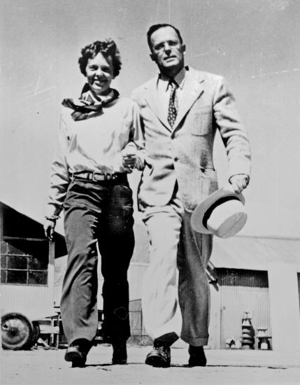 Amelia Earhart and George Palmer Putnam, a white woman and man respectively, pose informally.