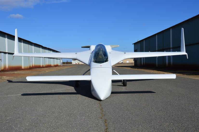 Front view of white monoplane with long tailplane and fin combo.