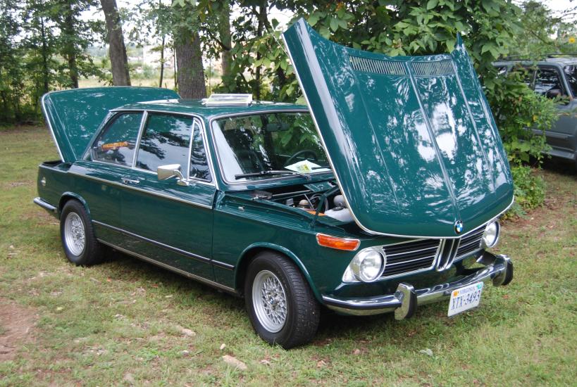 Side view of teal, four-door sedan automobile.