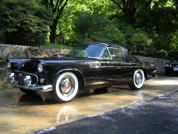 Side view of black, vintage two-door automobile.