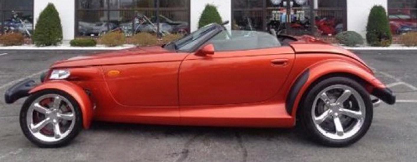 Side view of red, two-seat convertible automobile.