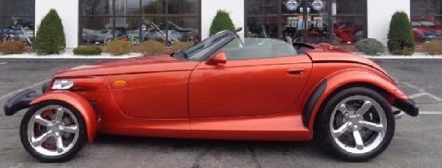 Side view of red, two-seat convertible automobile.