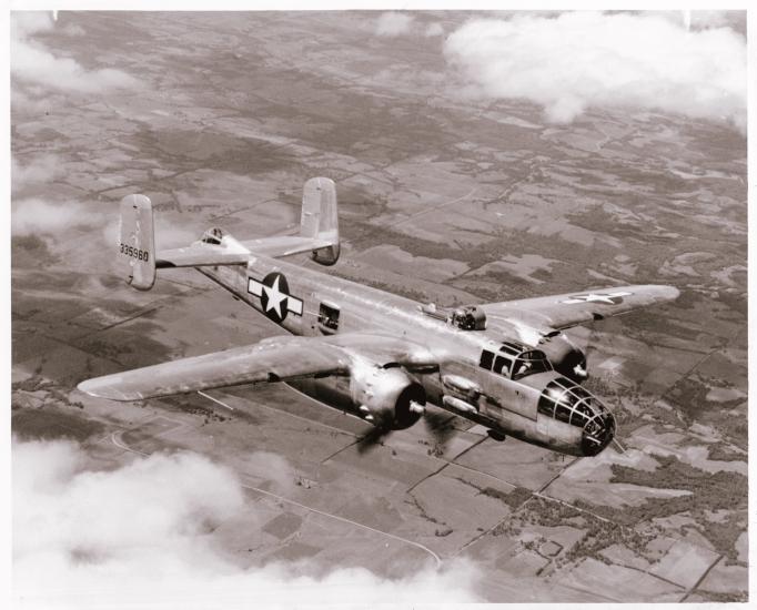 A bomber monoplane with twin engines in flight. Painting of a star near the rear of the fuselage indicates its status as a military monoplane.