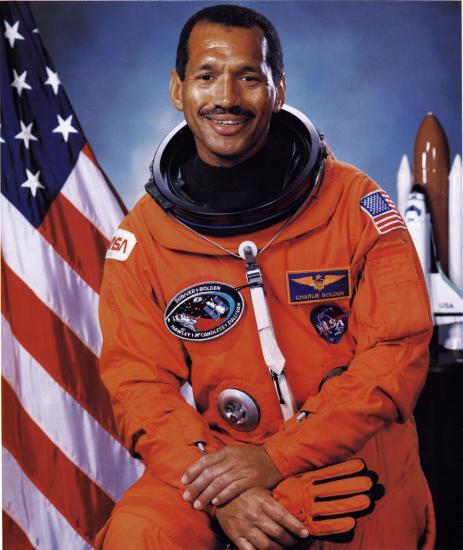 Charles F. Bolden Jr., an African-American male astronaut, poses formally in his astronaut suit.