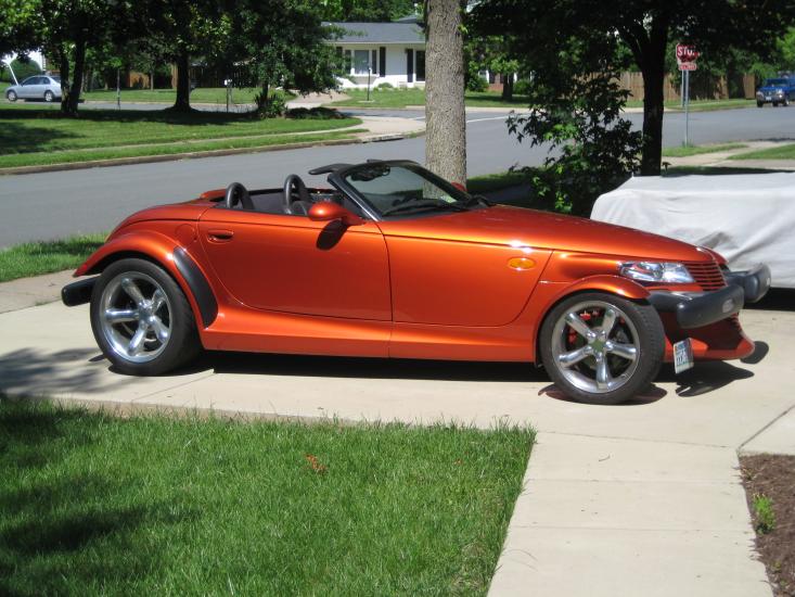 Side view of red, two-seat convertible automobile with two doors.