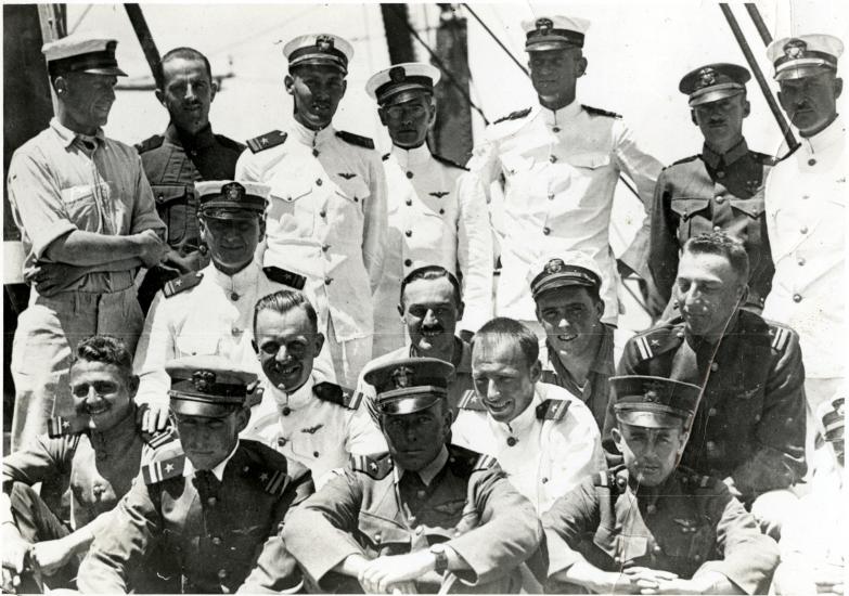 An informal photo of the original U.S.S. Langley pilots, who are in uniform. In the back row, Alfred Melville Pride stands second from the right and Godfrey Chevalier stands in the center.