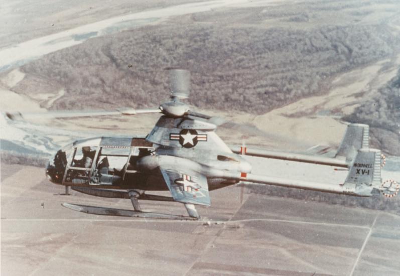 Side view of a gray, experimental aircraft designed like a helicopter but intended to have speeds similar to an airplane. A one-blade propellor is visible.