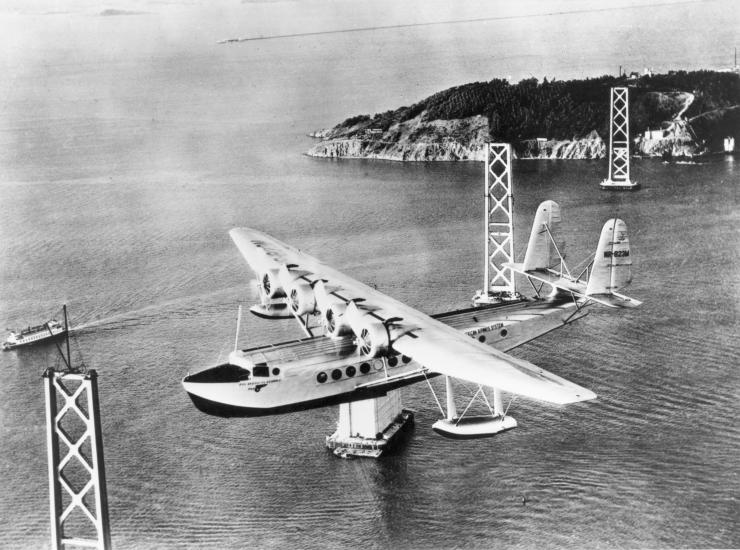 <em>Pan American Clipper</em> over San Francisco-Oakland Bay Bridge