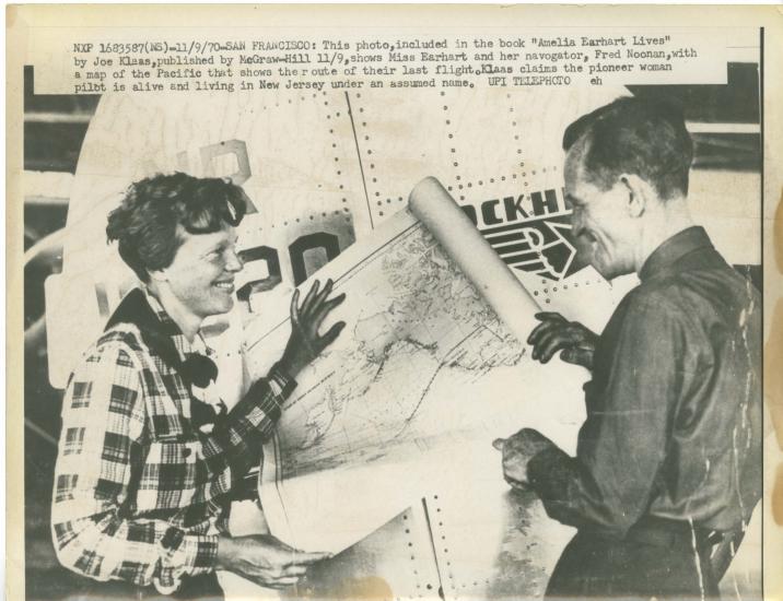 Amelia Earhart, a white female pilot, and Fred Noonan, a white male navigator, stand together looking at a map. A caption suggests a different ending to the flight that led to Earhart's disappearance.