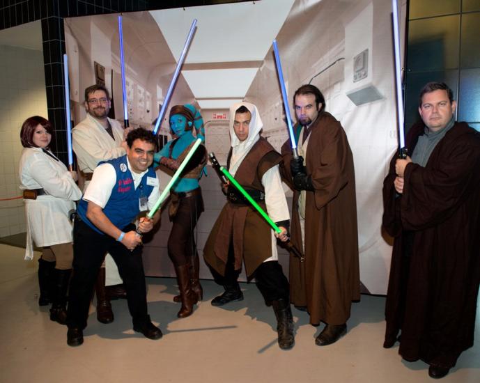 A Museum volunteer poses with people dressed in Star Wars costumes at the Museum's annual Halloween event.