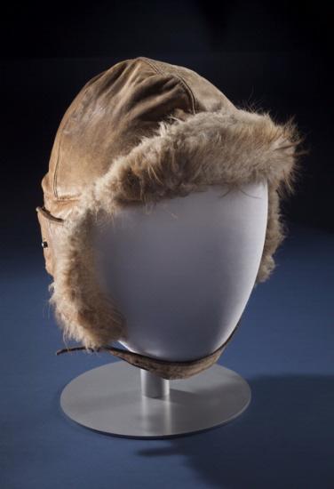 Brown aviation helmet with leather outer lining and fur-lined interior. Styled on mannequin.