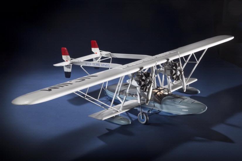 Diagonal front view of white-colored monoplane model. 