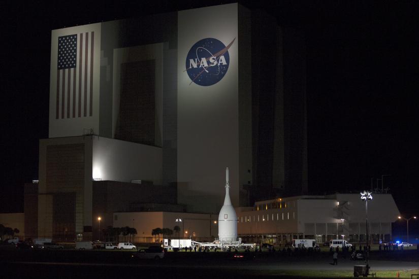 Orion Spacecraft Rolls Past the Vehicle Assembly Building