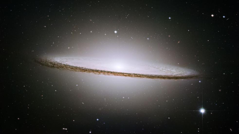 A disc-shaped galaxy that looks slightly like a sombrero.