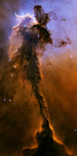 A nebula of dust and gases with orange and light purple colours.