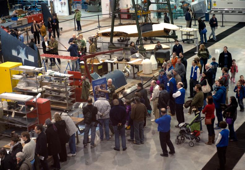 Second-floor view of Museum visitors touring the Museum's restoration hangar during an open house event.