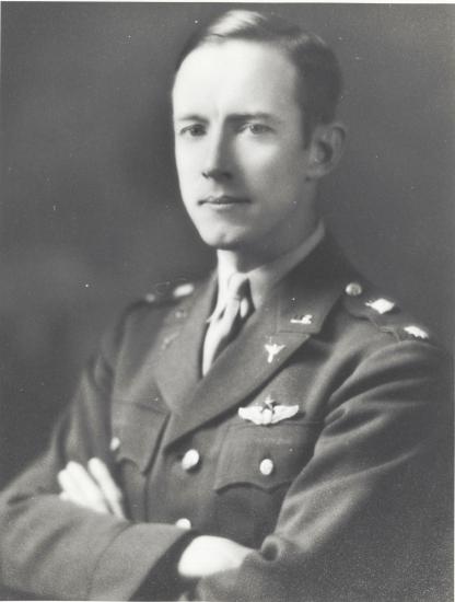 A white man in a military uniform looks at the camera.