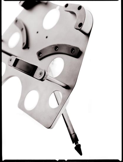 Art print of a restraint used during the Hubble spacewalk missions. The shape allows for two boots to be placed in the restraint.