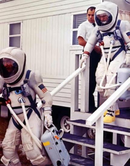 Gemini 7 prime crew leaves suiting trailer during prelaunch countdown