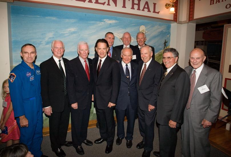 Group of men dressed in suits for an event pose for a photograph inside the Museum.