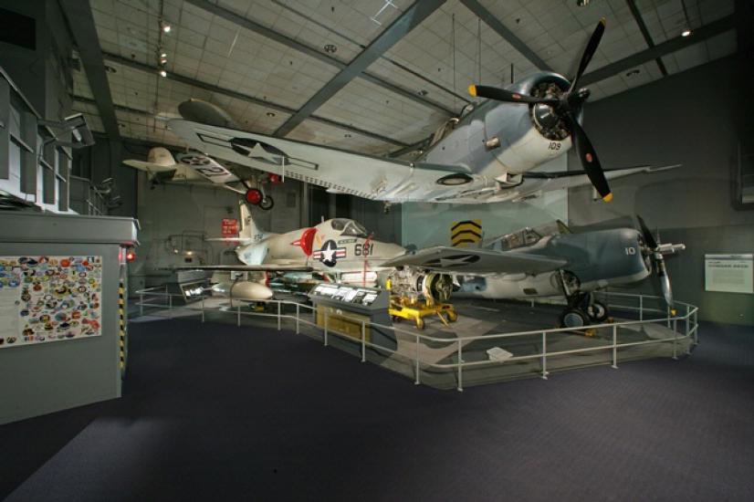 Planes are suspended in the air and sit on the floor in the Sea-Air Operations gallery.